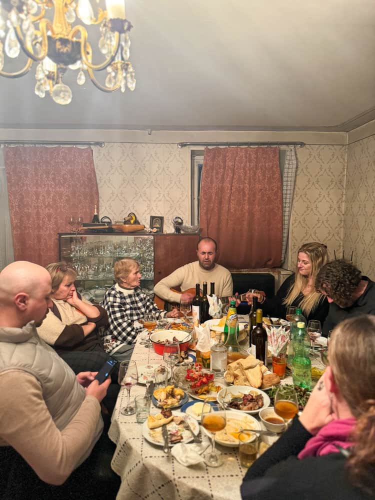A group of people around a table with food.
