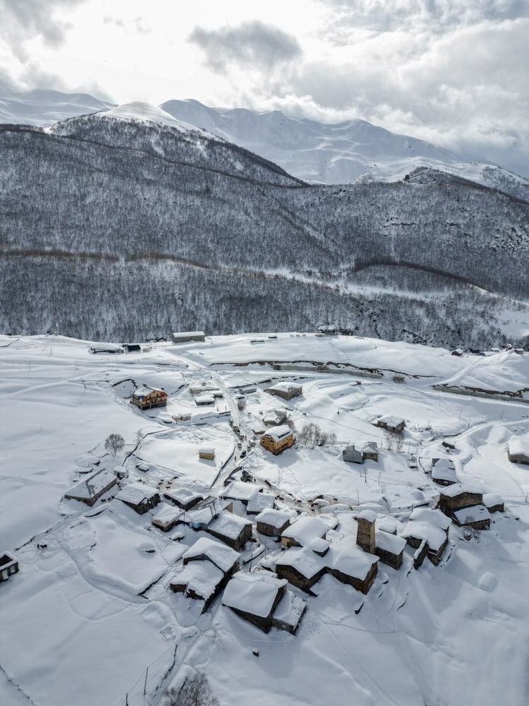 An aerial view of a village covered in snow.